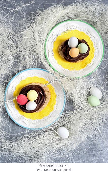 Cookies with chocolate ganache and sugared almonds in the shape of an Easter basket