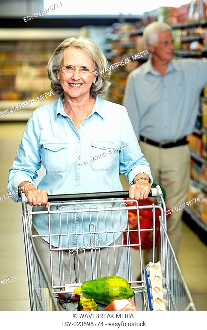 Smiling senior couple buying food