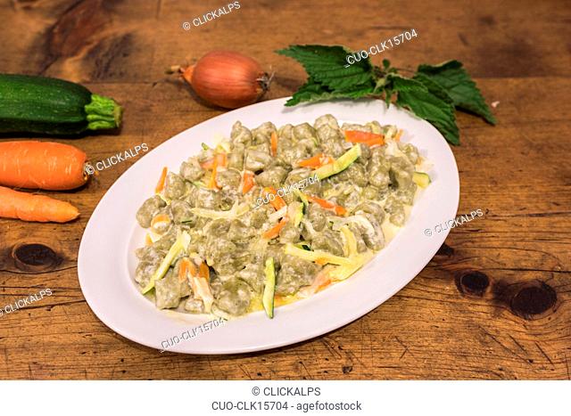 Plate of gnocchi with vegetables and cheese, San Romerio Alp, Brusio, Canton of Graubünden, Poschiavo valley, Switzerland, Europe