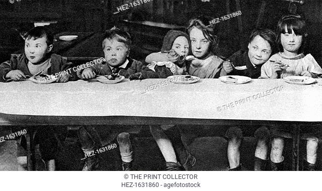 East End children being fed by a charitable organisation, London, 1926-1927. From Wonderful London, volume II, edited by Arthur St John Adcock