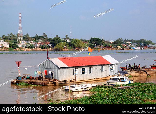 Boat and houses on the riverbank of Mekong in Chaudok, Vietnam
