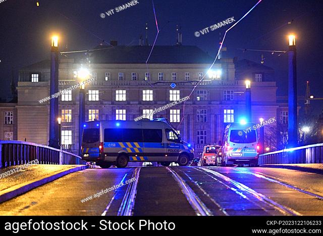 A police officer patrols the closed Manes Bridge heading towards Jan Palach Square, where shots were fired in the Faculty of Arts building, in Prague
