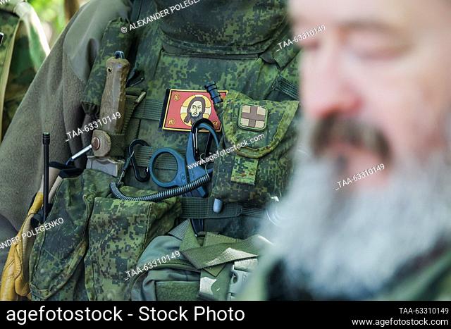 RUSSIA - OCTOBER 11, 2023: A serviceman stands beside Archpriest Dmitry Vasilenkov of the St Petersburg Eparchy as he visits a company of the 1st battalion