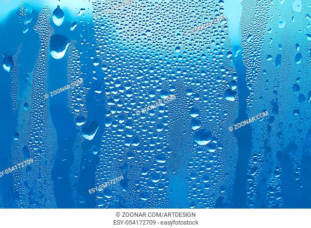 blue texture of water drops on glass
