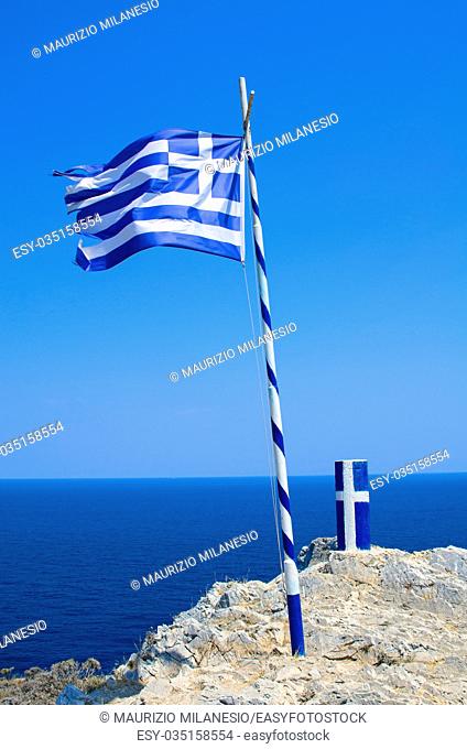 Flag and pylon with insignia of Greece, near Kastro on the island of Skiathos