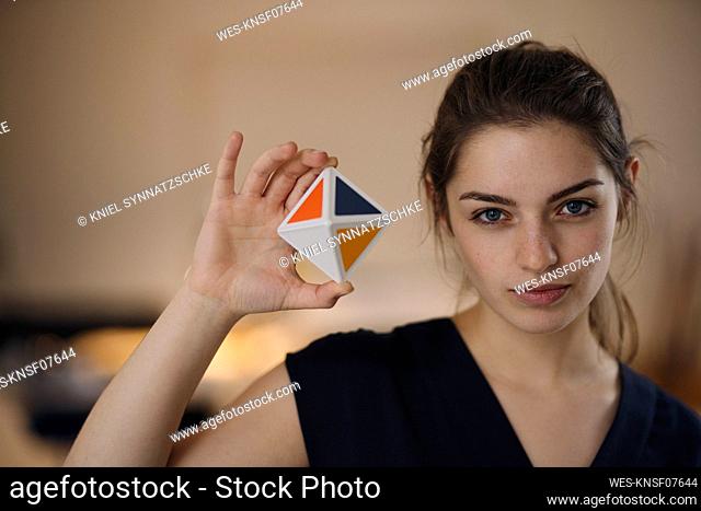 Portrait of young woman time management cube
