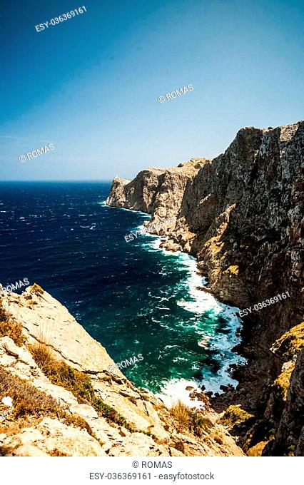 Famous Cap de Formentor, cliff on the northern part of Mallorca island, Spain. Big rocky mountains with lighthous in distance
