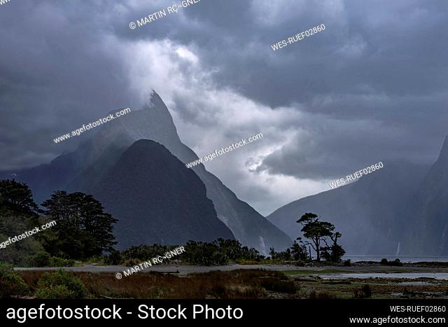 New Zealand, Southland, Gray storm clouds over Milford Sound