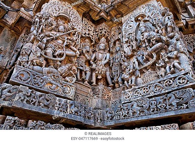 Ornate wall panel reliefs depicting dancing Shiva on the left and dancing Sarswati on the right, Hoysaleshwara temple, Halebidu, Karnataka, India