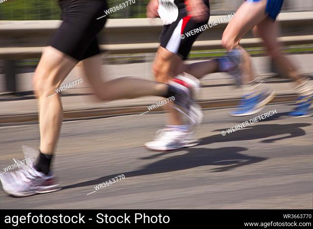 Germany, Baden-Wurttemberg, Stuttgart, Three runners in motion during half marathon