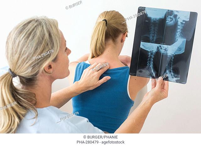 Doctor looking at a of the cervical spine x-ray of her patient