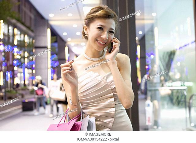 Young woman shopping and talking on the phone