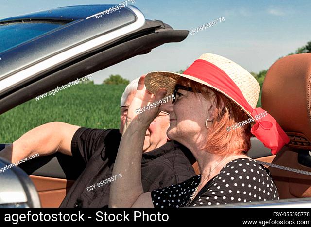 Senior woman with partner driving a car