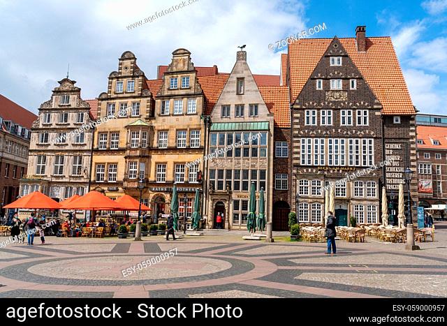Bremen, Germany - May 25, 2021: colorful old guild houses on the market square in the historic old city center of Bremen with cafes outside