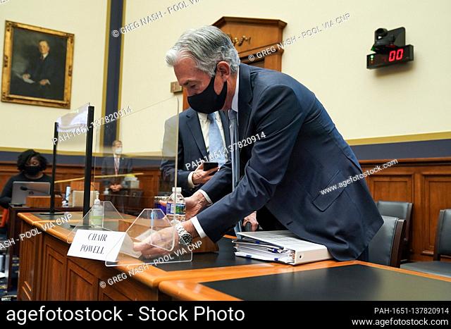 Federal Reserve Chairman Jerome Powell adjusts his name placard as he arrives for a House Financial Services Committee oversight hearing to discuss the Treasury...