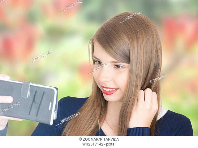 Portrait of beautiful young girl with phone