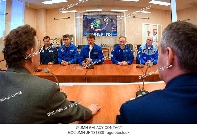 The Expedition 9 prime and backup crewmembers speak to members of the State Commission from behind glass at building 254 at the Baikonur Cosmodrome, Kazakhstan