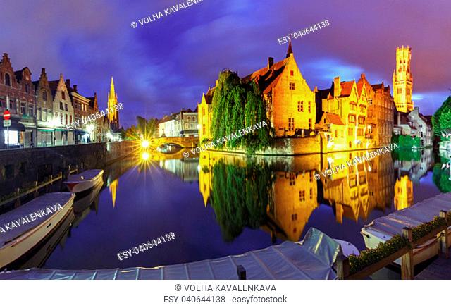 Scenic cityscape with tower Belfort and Church of Our Lady from the quay Rosary, Rozenhoedkaai, at night in Bruges, Belgium
