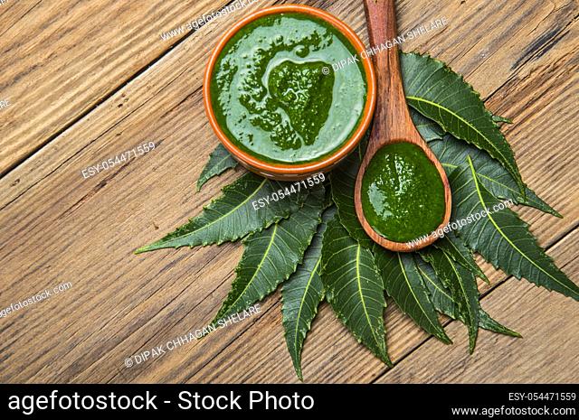 Medicinal Neem leaves with paste on wooden background