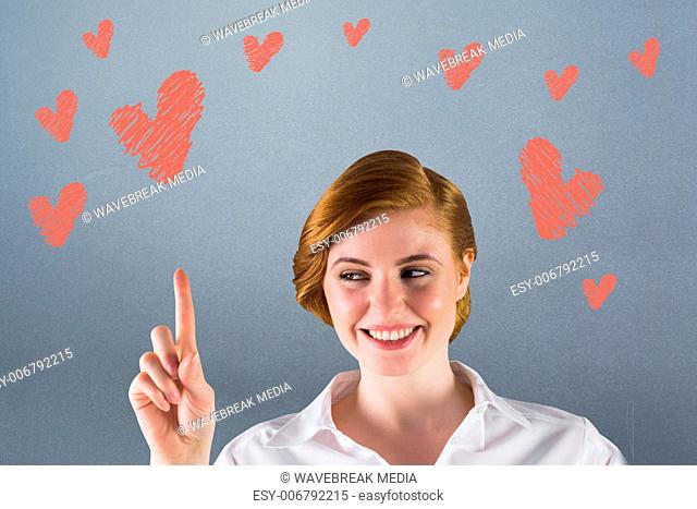 Composite image of businesswoman smiling and pointing