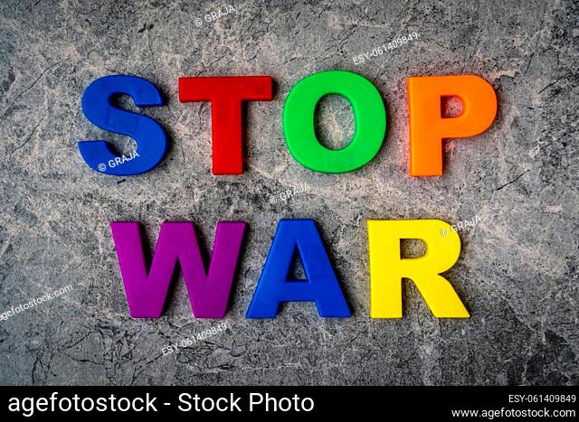 The inscription Stop War in plastic letters on a stone background. Stop war, stop aggression