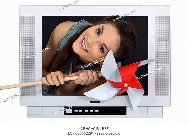 Woman coming out from TV with a grinder