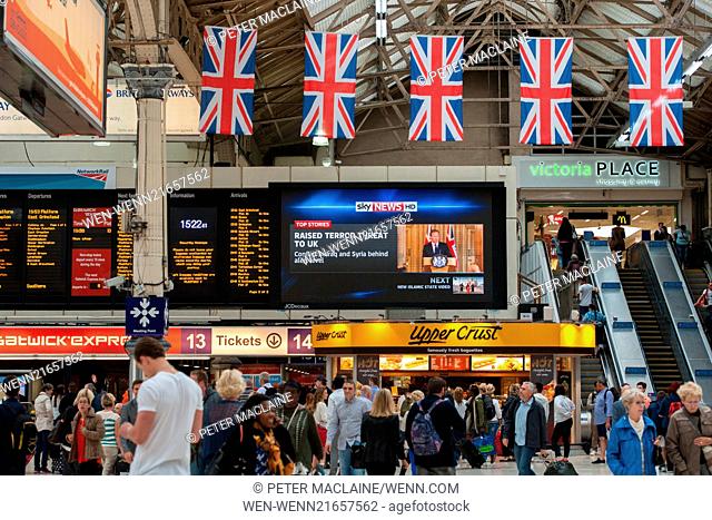 On a giant screen in Victoria Station a Sky News feed announces the raised terror threat level in the UK. Featuring: Atmosphere, View Where: London