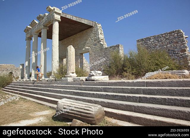 Tourist woman at the stairs of the Ionic Stoa in the Archeological area of Milet, Miletus, Aydin Province, Turkey, Europe