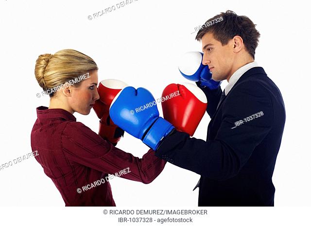 Man and woman with boxing gloves opposing each other