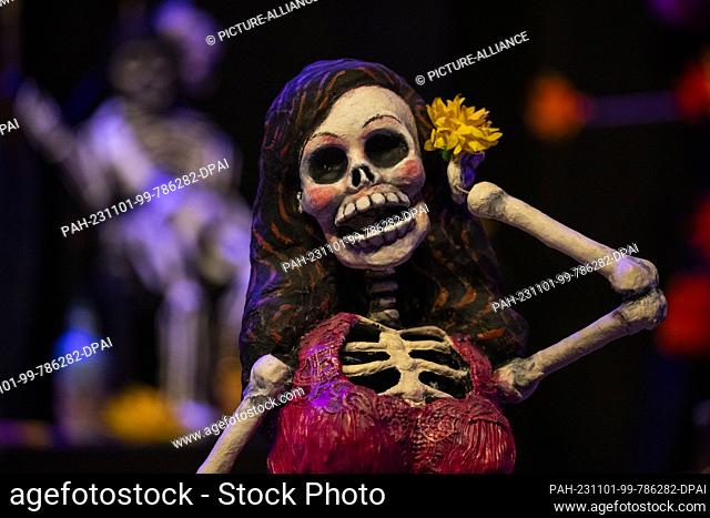 01 November 2023, Berlin: A skeleton figure stands on the built-up altar in the Humboldt Forum. During the festival, the dead return from the afterlife to the...