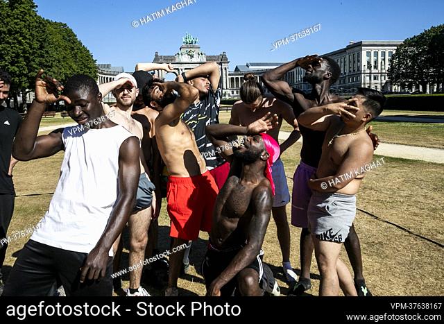 Youngster theatrically show how they suffer during the heath wave in Brussels on Tuesday 19 July 2022. The Royal Meteorological Institute - KMI - IRM announces...