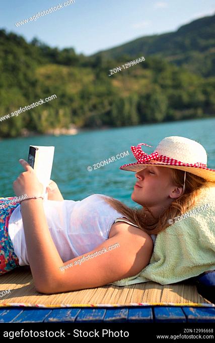 hipster girl reading a book on the boat