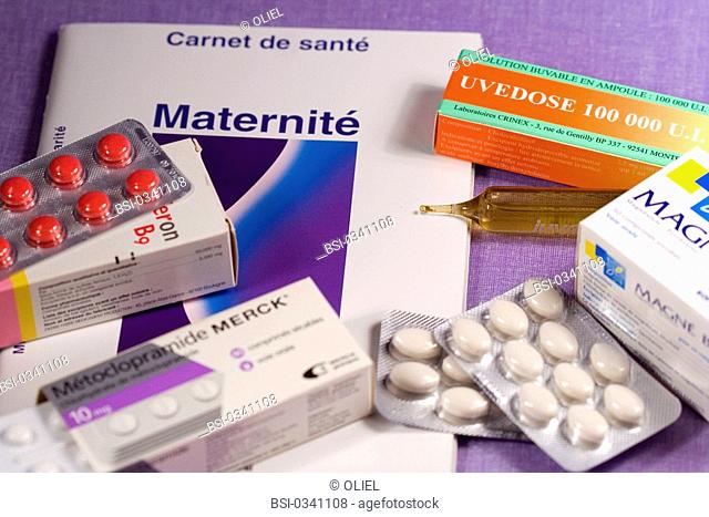 PREGNANT WOMAN TAKING MEDICATION Assortment of different food supplements used by pregnant woman. Uvedose is a food supplement vitamin D3-based cholecalciferol