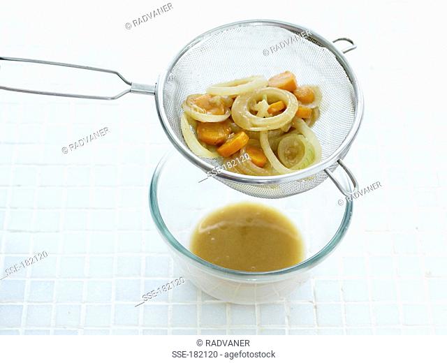 Passing the sauce through a sieve