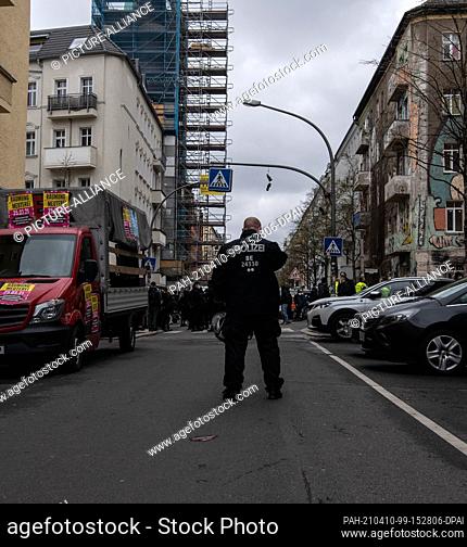 10 April 2021, Berlin: A police officer stands in Rigaer Straße. There the participants in the demonstration ""Liebig 34 is everywhere!"" met