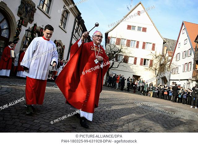 25 March 2018, Germany, Rottenburg/Neckar: Bishop Gebhard Fuerst gives Palm Sunday blessings during a parade in the town centre