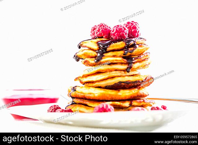 Delicious cottage cheese pancakes with fresh raspberry and chocolate sirup. Curd fritters