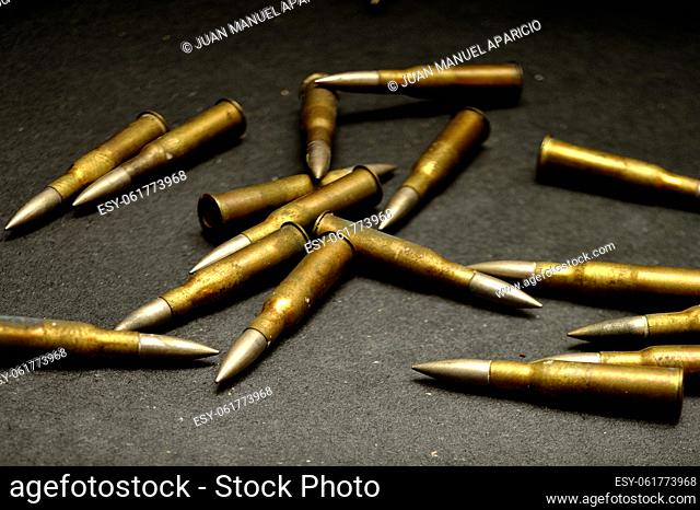 Several large-caliber bullets lying in a chaotic