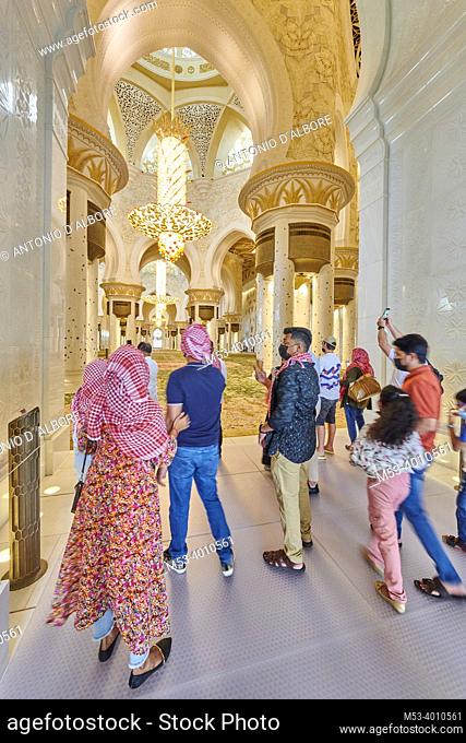 Tourists taking photos at the entrance of the prayer room at Sheikh Zayed Mosque. Abu Dhabi. United Arab Emirates
