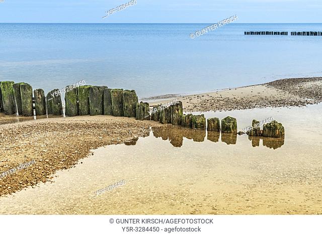 Old Groynes at the beach of the Baltic Sea near Kolobrzeg. Groynes are intended to break the shaft and to prevent the erosion of the coast