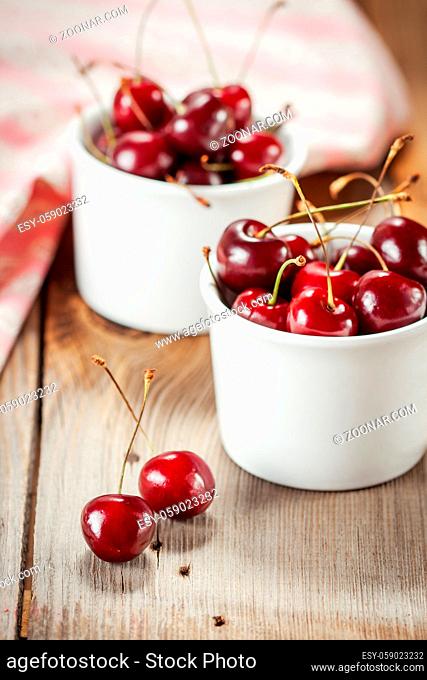 Berries sweet cherries in a white bowls