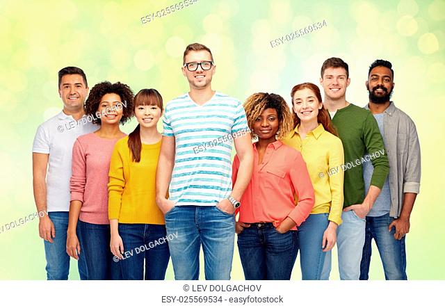 diversity, race, ethnicity and people concept - international group of happy smiling men and women over summer green lights background