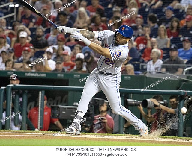 New York Mets first baseman Dominic Smith (22) swings at a pitch in the dirt in the first inning against the Washington Nationals at Nationals Park in...