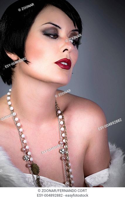 gourgeos female brunette flapper wearing pearls and fur