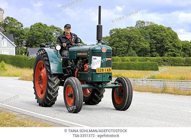 Kimito, Finland. July 6, 2019. Bolinder-Munktell tractor year 1956 and driver on Kimito Traktorkavalkad, annual vintage tractor show and parade