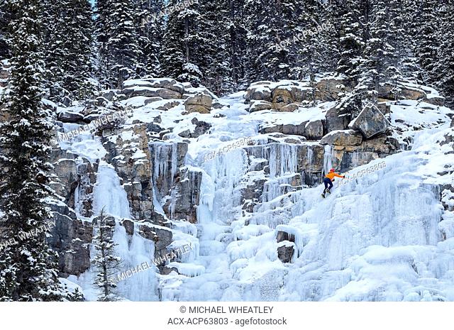 Ice climber on frozen Tangle Falls, Jasper National Park, Alberta, Canada