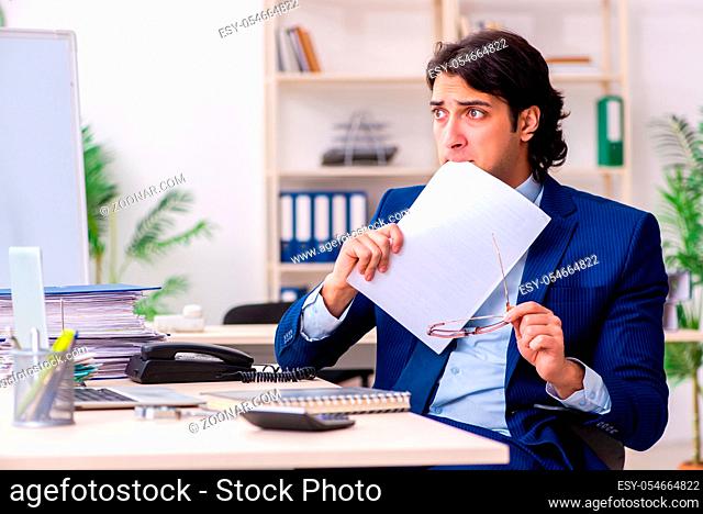 The young businessman sitting and working in the office
