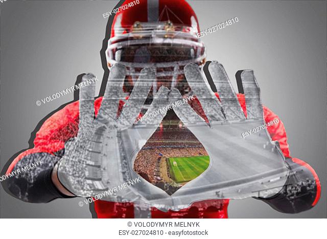 The conceptual image of hands of american football player with stadium