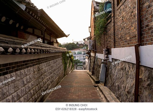 Traditional Bukchon Hanok village alleyway with brick houses and narrow streets lined with traditional korean architecture walls