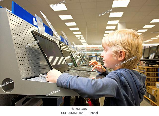 Little boy is testing a laptop computer